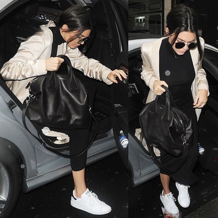 Kendall Jenner keeps travel dressing streamlined and polished, relying on comfortable, clean white sneakers to ground a tailored black-and-cream airport look