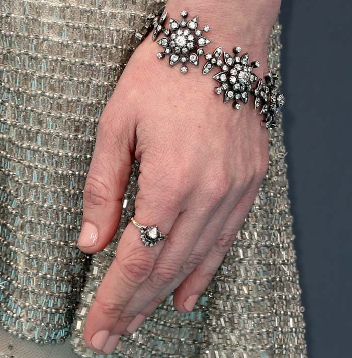 A vintage-inspired Fred Leighton bracelet and statement ring add a refined, heirloom sparkle against the gown’s intricate beading