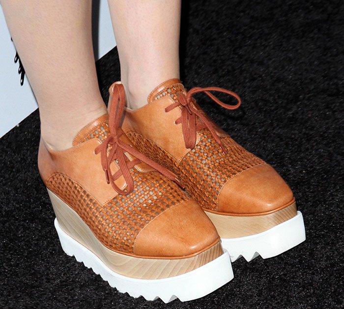 Lily Collins completed the look with woven leather Stella McCartney Elyse platform oxfords, featuring almond cap toes, natural wood wedge heels, and the collection's signature saw-tooth rubber soles