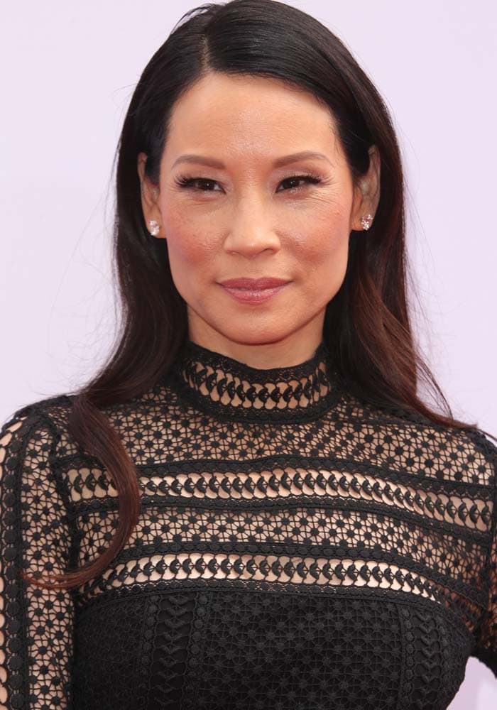 Lucy Liu exuded timeless elegance in a black lace Self-Portrait dress featuring intricate cutout detailing and a high neckline