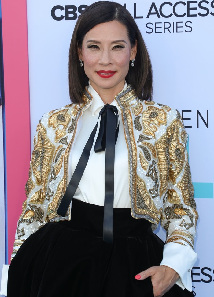 Lucy Liu added a touch of opulence to her look with an embellished cropped jacket by Alexandre Vauthier, featuring gold embroidery, sequined detailing, and structured shoulders for a polished yet statement-making finish