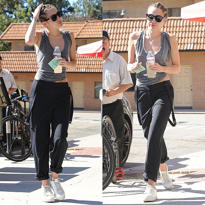 Miley Cyrus relaxes tailored dressing by pairing well-fitting dress pants with classic white trainers, striking an easy balance between polish and comfort