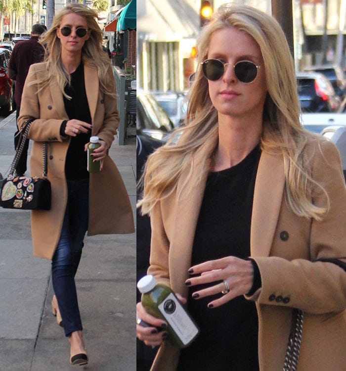 Nicky Hilton carries a bottle of juice in a camel coat and a pair of Rag Bone skinny jeans