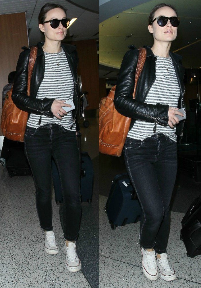 Olivia Wilde exudes casual cool at LAX in Amo Babe jeans, a Balenciaga leather jacket, Smoke x Mirrors sunglasses, and classic Converse Chuck Taylor sneakers