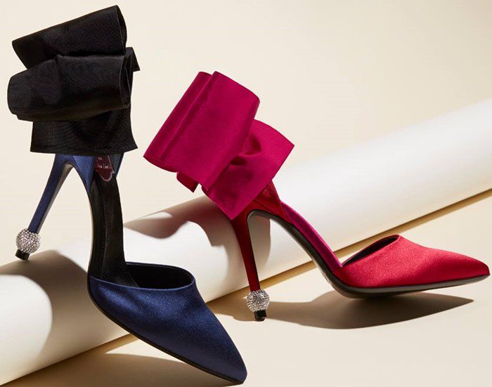 Roger Vivier’s “Papillon de Nuit” design transforms the classic pump into a sculptural object, with oversized satin bows and crystal-tipped heels creating movement from every angle