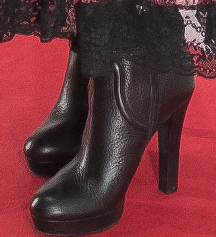 Penélope Cruz grounded her flowing bohemian dress with towering black platform ankle boots, adding a sharper, more structured finish to the romantic lace details