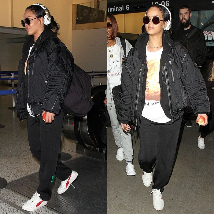 Rihanna keeps airport style effortlessly cool, grounding her hoodie-and-sweatpants travel look with crisp white sneakers at Los Angeles International Airport (LAX) on January 8, 2016