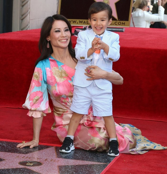 Lucy Liu looked radiant in a Peter Pilotto Spring 2019 one-shoulder silk maxi dress featuring a dégradé floral print, soft draping, and a matching sash