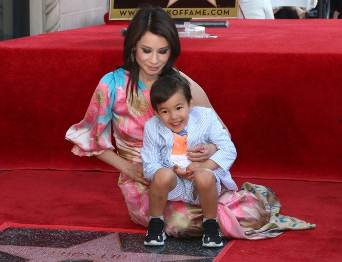 Lucy Liu shares a tender moment with her son, Rockwell Lloyd Liu, while celebrating her Hollywood Walk of Fame star in a floral Peter Pilotto gown