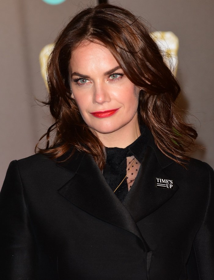 Ruth Wilson exudes elegance with her soft waves, bold red lipstick, and a powerful 'Time's Up' pin at the BAFTAs