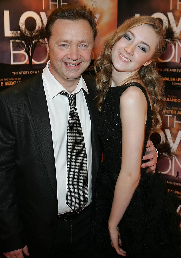 Saoirse Ronan looks elegant in a textured black sleeveless dress as she poses with her father, Paul Ronan, at the Irish premiere of The Lovely Bones at the Savoy Cinema in Dublin on January 26, 2010
