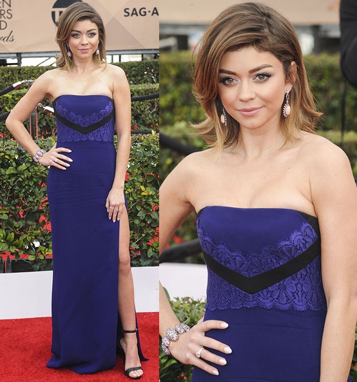 Sarah Hyland showcases the lace-detailed bodice of her J. Mendel gown, accessorizing with stacked statement bracelets and coordinating cocktail rings