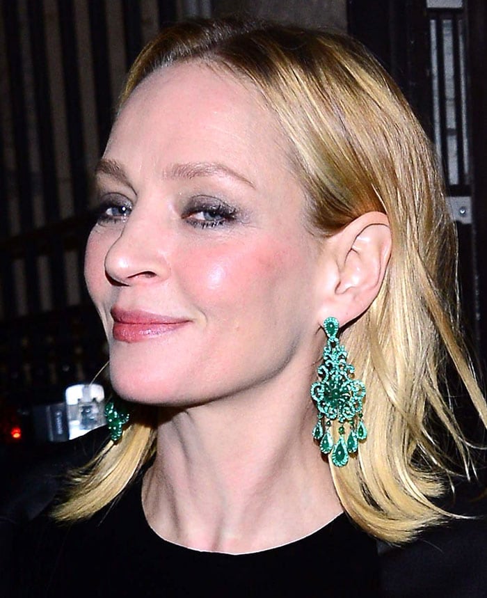 Uma Thurman styled her blonde hair in a sleek, shoulder-length cut, allowing her stunning emerald chandelier earrings to take center stage