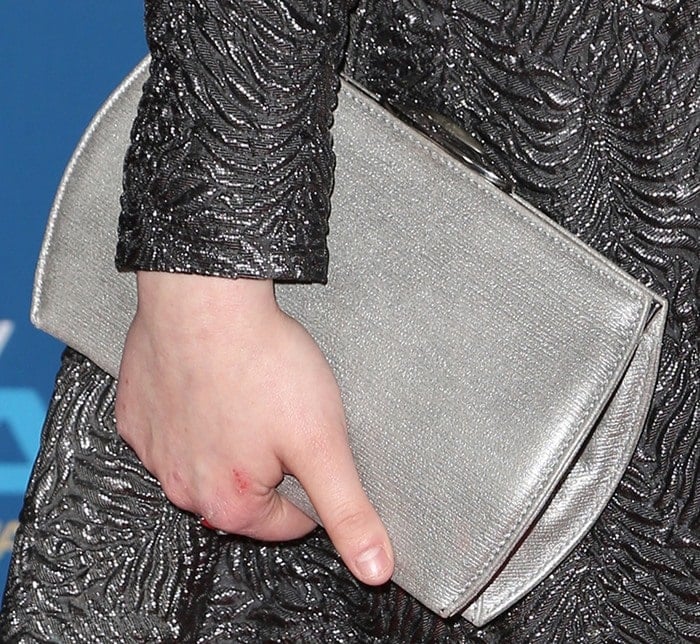 The actress accented her textured evening ensemble with a sleek silver Ella McHugh clutch that echoed the gown's metallic finish