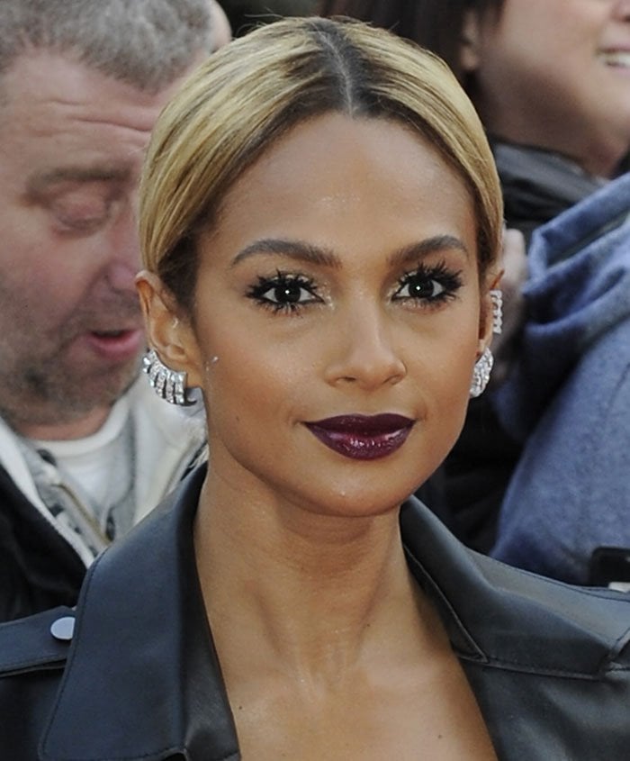 A plum lip, dramatic lashes, and diamond earrings complement Alesha Dixon's gladiator-inspired ensemble