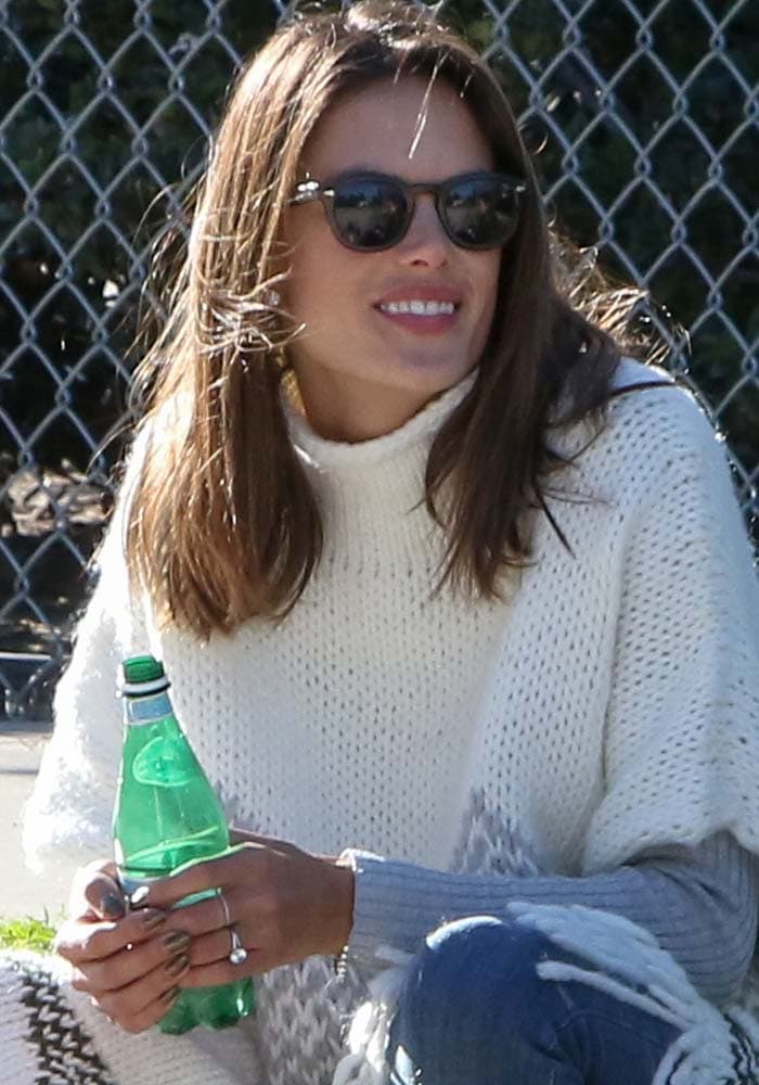 Alessandra Ambrosio wears a knitted poncho by Elizabeth James