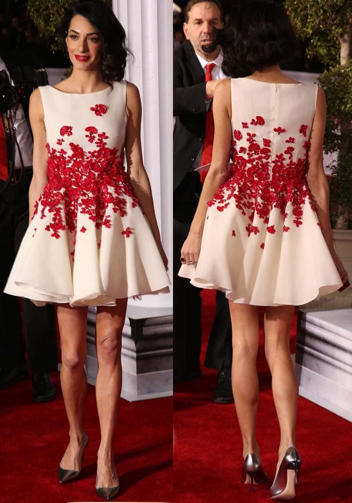 Amal Clooney paired a floral-embellished Giambattista Valli mini dress with metallic Christian Dior "Songe" pumps, creating a striking contrast between romantic detailing and sleek silver footwear