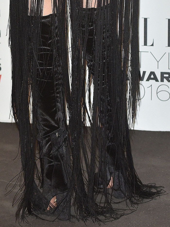 A closer look reveals Bella’s black velvet Altuzarra thigh-high boots peeking through the cascading fringe