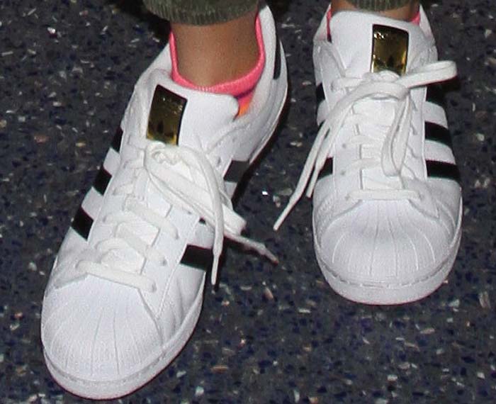 Bella Thorne steps out in classic Adidas 'Superstar' sneakers, adding a sporty touch to her airport look