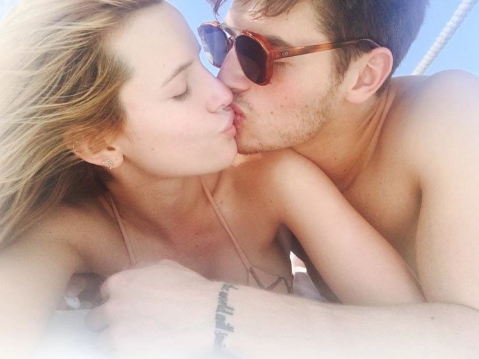 Bella Thorne shares a sweet kiss with Gregg Sulkin during their romantic getaway