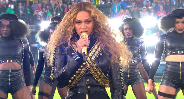 Beyoncé stuns in a custom DSquared2 military-style jacket paired with voluminous curls