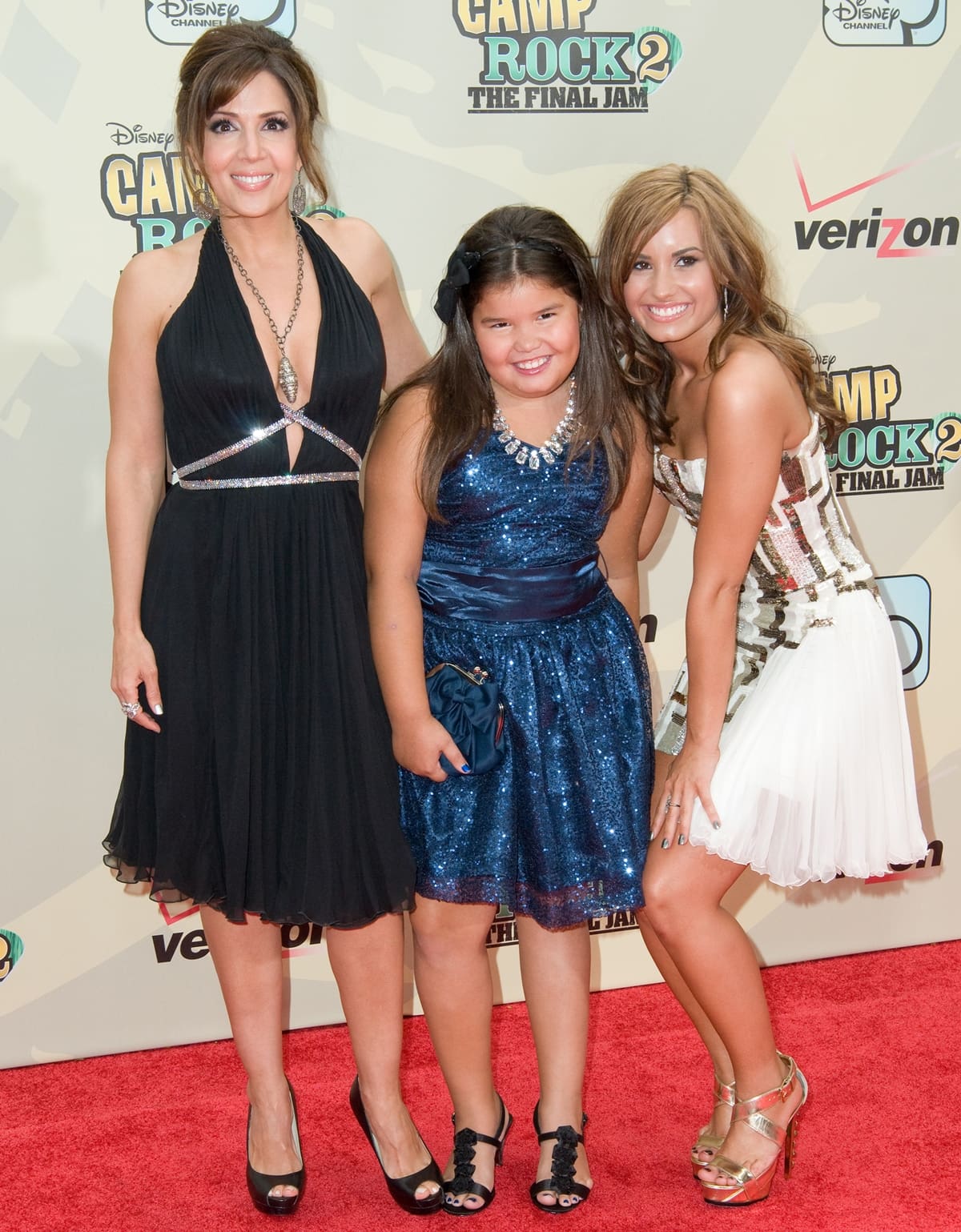 Maria Canals-Barrera, Madison De La Garza, and Demi Lovato shine on the red carpet at the Camp Rock 2: The Final Jam premiere, with Demi elevating her look in a sequined Georges Chakra dress and gold Ruthie Davis platform heels