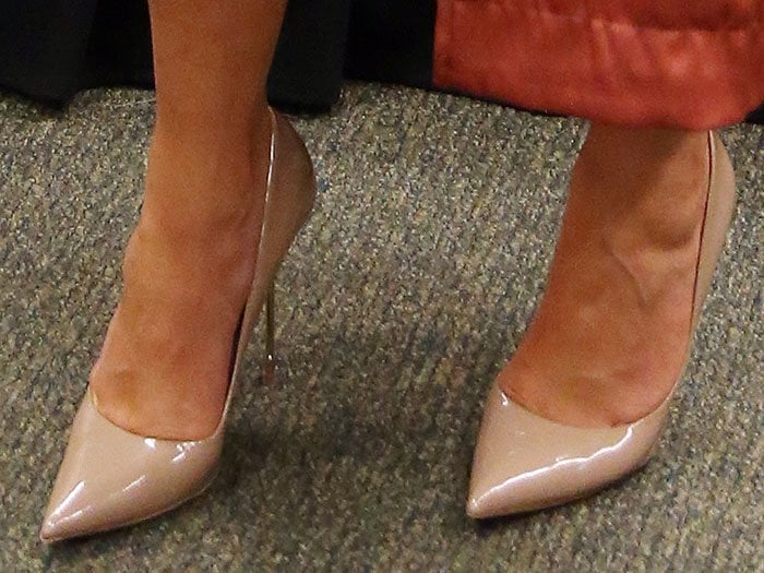 Chrissy Teigen steps out in nude leather Kurt Geiger “Britton” pumps, the glossy pointed-toe stilettos elongating her silhouette with understated polish