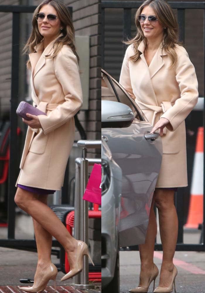 Elizabeth Hurley exudes elegance in a nude trench coat paired with matching pointed-toe pumps and a violet clutch, effortlessly combining sophistication and style