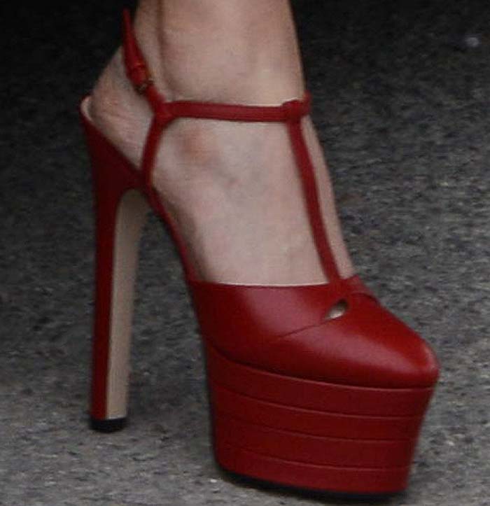 A detailed look at Elizabeth Olsen’s bold red Gucci “Angel” platform heels featuring towering stacked soles and slender T-straps