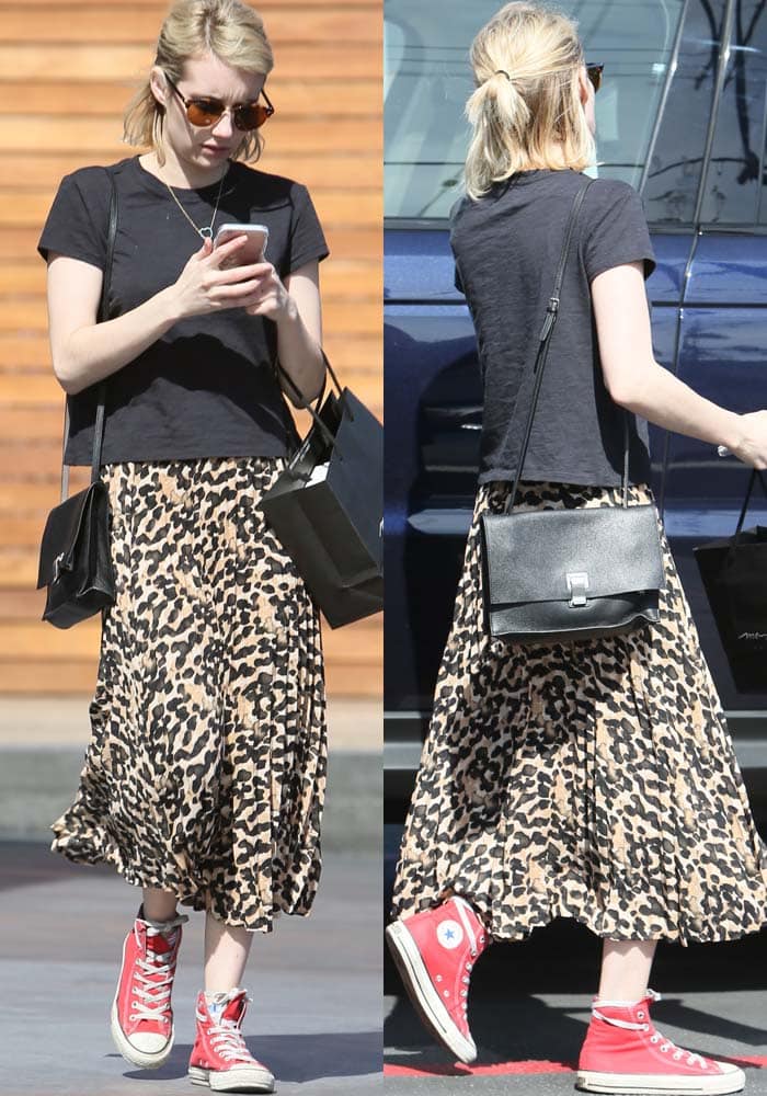 Emma Roberts pairs a black t-shirt with an ankle-length leopard skirt while out in Los Angeles