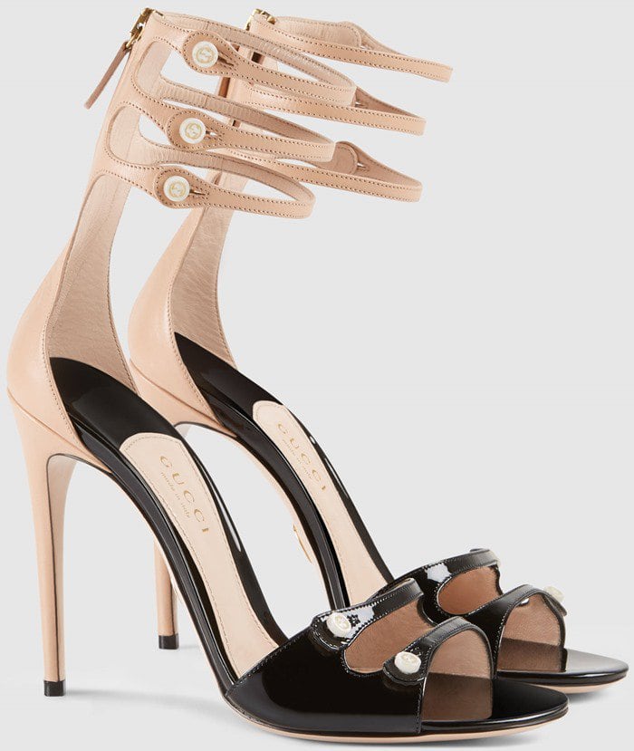 Shown here in a blush-and-black colorway, the sandals highlight the playful button detailing and sculptural cage-like ankle design that made the style a standout from Gucci's early Michele era