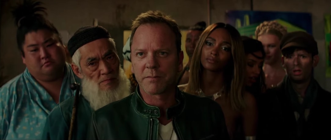 Jourdan Dunn as Natalka, alongside Kiefer Sutherland and other members of Hansel's eclectic group of lovers, in Zoolander 2