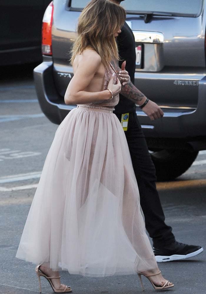 Jennifer Lopez embraced a romantic monochromatic palette in a blush Valentino tulle halter dress and nude patent Giuseppe Zanotti "Coline" sandals at the American Idol finale in Los Angeles
