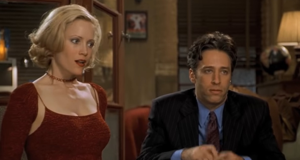 Leslie Mann, portraying Corinne Maloney with enhanced prosthetics for comedic effect, shares a scene with Jon Stewart as Kevin Gerrity in the hit comedy Big Daddy