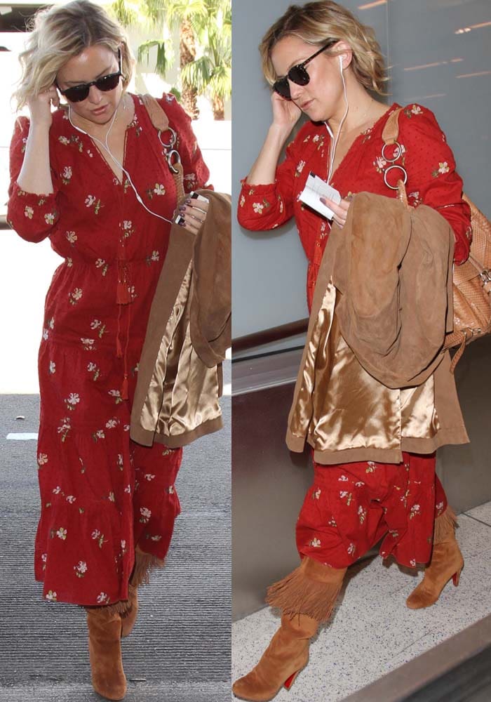 Carrying a suede coat and woven handbag, Kate Hudson leans into effortless California-boho styling with floral prints and statement fringe boots at Los Angeles International Airport