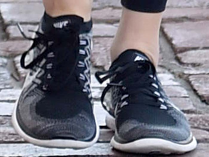 Close-up of Kendall Jenner's feet wearing black and gray Nike Free 4.0 Flyknit running shoes