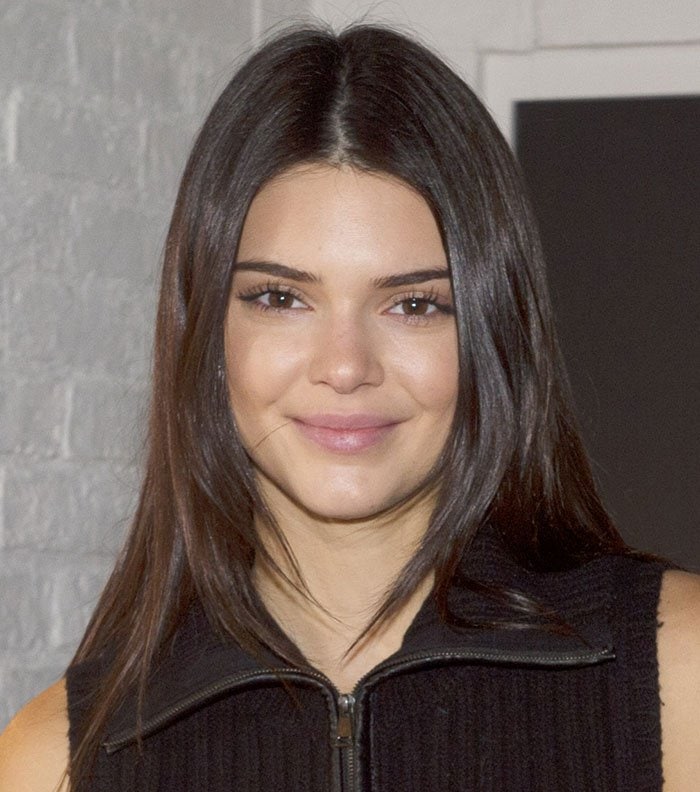 Kendall Jenner's center-parted dark locks and a barely there makeup finished off her look