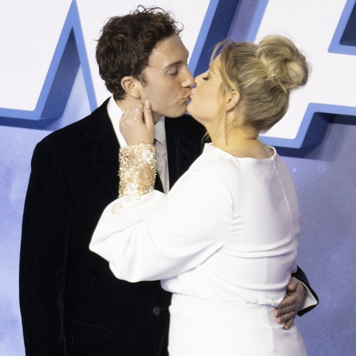 Meghan Trainor and Daryl Sabara shared a kiss on the blue carpet as the singer showed off the crystal-embellished cuffs of her flowing Badgley Mischka Couture gown at the Star Wars: The Rise of Skywalker premiere in London