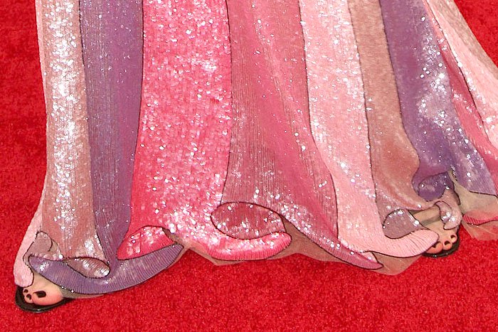 A glimpse beneath the sweeping hem revealed the gown's illusion-like ruffle detailing extending to the floor, where flashes of Kidman's black patent Gucci sandals peeked through