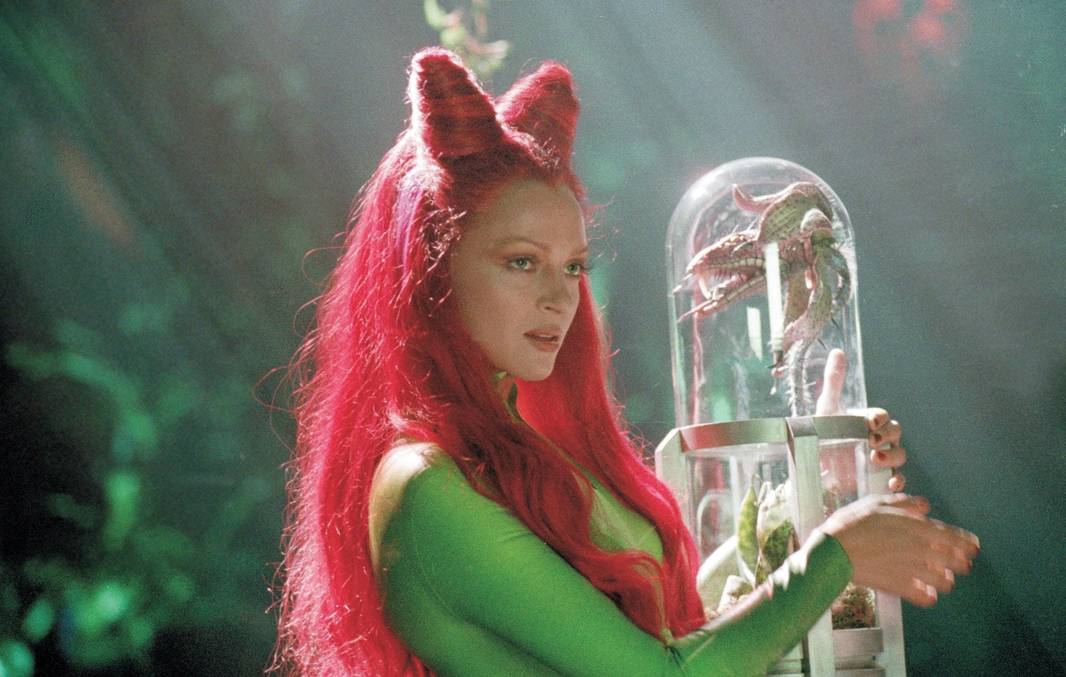 Uma Thurman embodies the seductive and dangerous Poison Ivy as she carefully handles a plant specimen in the 1997 film Batman Robin