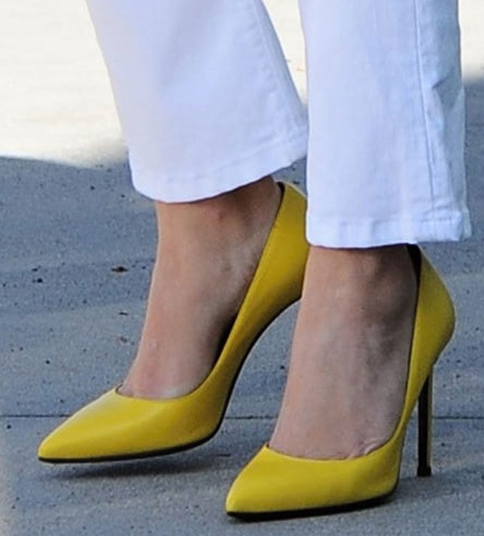 These sunshine-yellow stilettos instantly elevate Reese Witherspoon’s petite 5ft 1½ frame, adding over 4 inches of height while elongating her legs for a sleek, confident silhouette