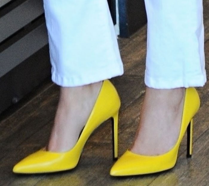 Reese's vibrant yellow pumps feature a sleek pointed toe and soaring stiletto heel, combining bold color with classic, leg-lengthening elegance