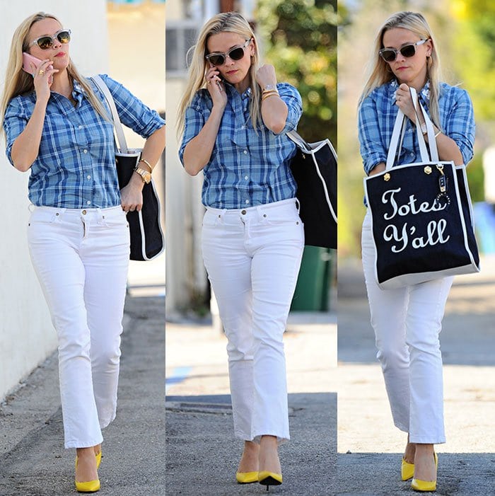 Reese Witherspoon nails casual Southern charm in a blue plaid Draper James shirt, white cropped jeans, and bold yellow Saint Laurent Paris pumps, topped off with her playful “Totes Y’all” bag