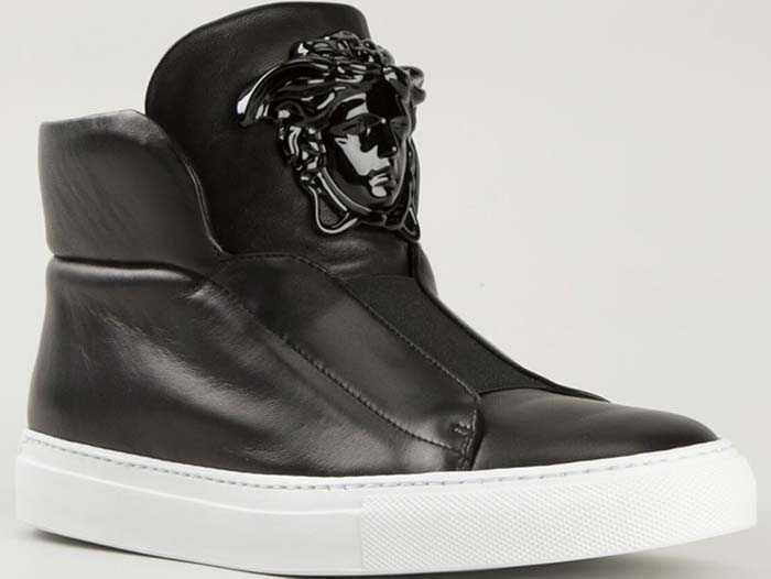 Versace Medusa high-top sneakers in smooth black leather feature a glossy tonal Medusa head plaque at the tongue, a padded ankle collar for structure, and a thick white rubber sole that sharpens the contrast and grounds the silhouette