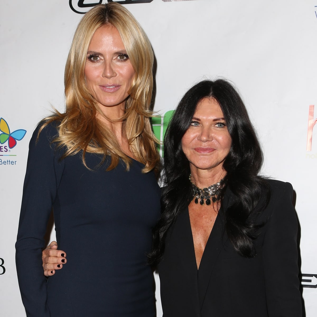 Heidi Klum, in a navy dress, poses with hairstylist Wendy Iles at the Hollywood Beauty Awards, where Iles received an award