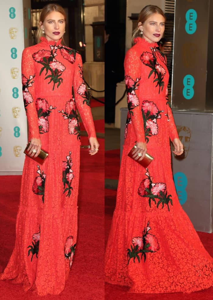 Dree Hemingway turned heads in a bold red Erdem lace gown embroidered with vibrant pink florals, a striking look that drew mixed reviews on the BAFTA red carpet