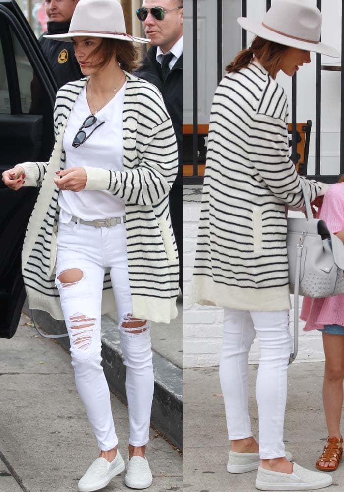 Alessandra Ambrosio pairs a chic striped cardigan with distressed white jeans and slip-on sneakers for a casual yet stylish look while out in Los Angeles