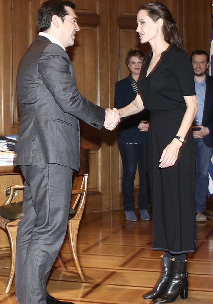 Angelina Jolie greets Greek Prime Minister Alexis Tsipras while wearing an all-black ensemble anchored by pointed Isabel Marant ankle boots at the Presidential Palace in Athens