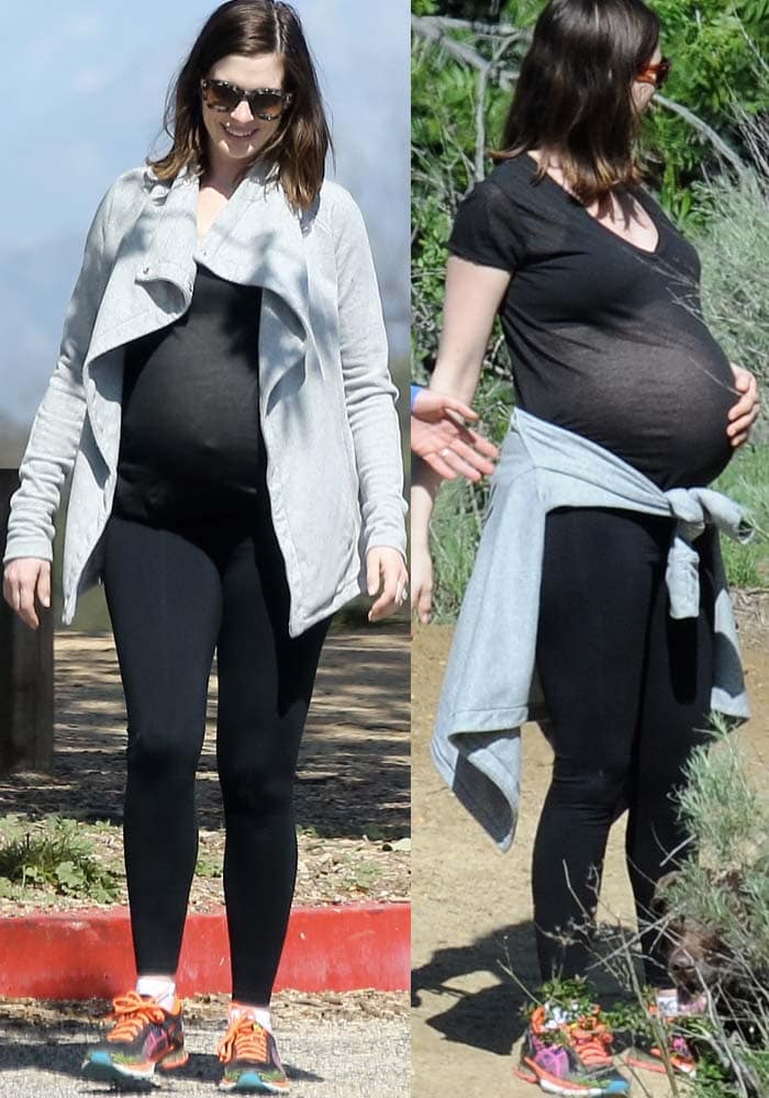 Anne Hathaway keeps her hike look simple and functional in a black tee and leggings, grounding the outfit with colorful Asics Gel-Kinsei running shoes built for comfort and support