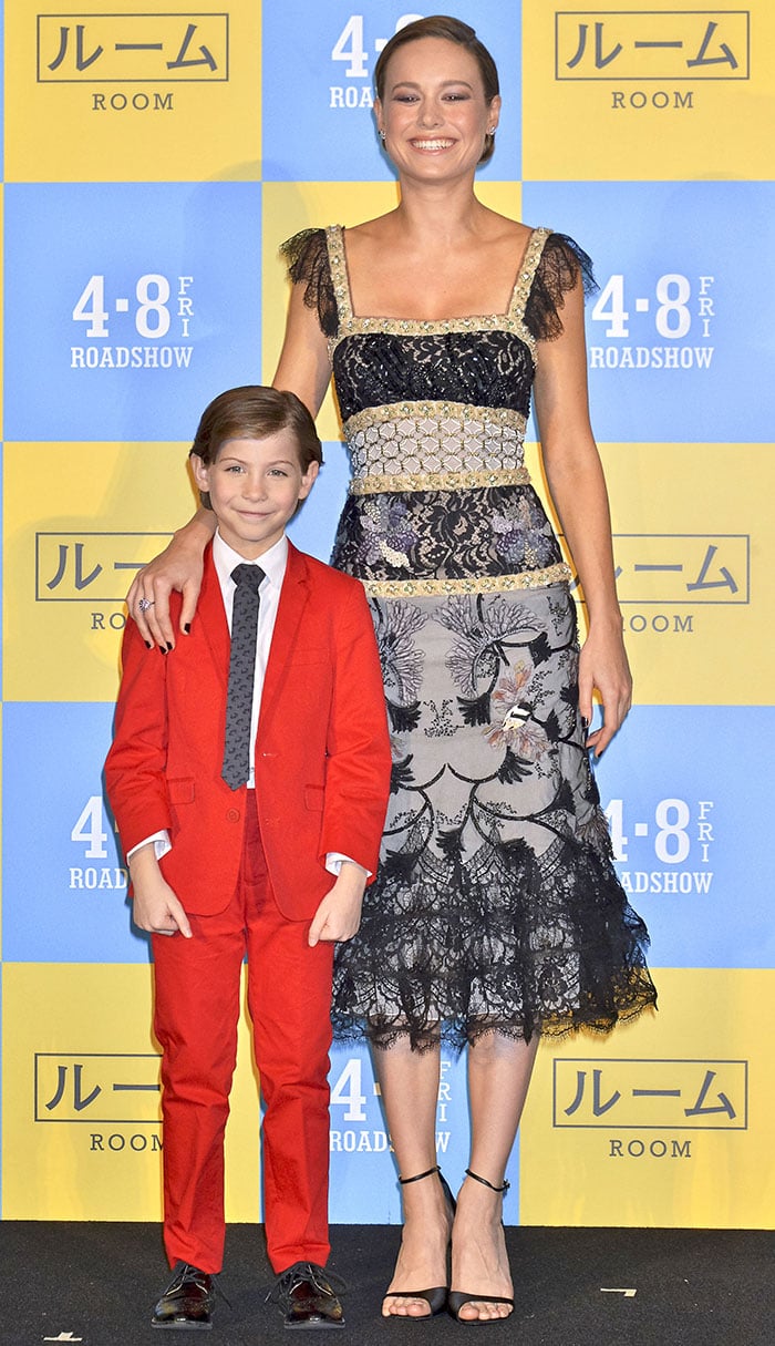 Brie Larson stunned in a hand-beaded Rodarte lace dress and Roger Vivier sandals while posing with Jacob Tremblay in a bold red suit at the Room Tokyo premiere